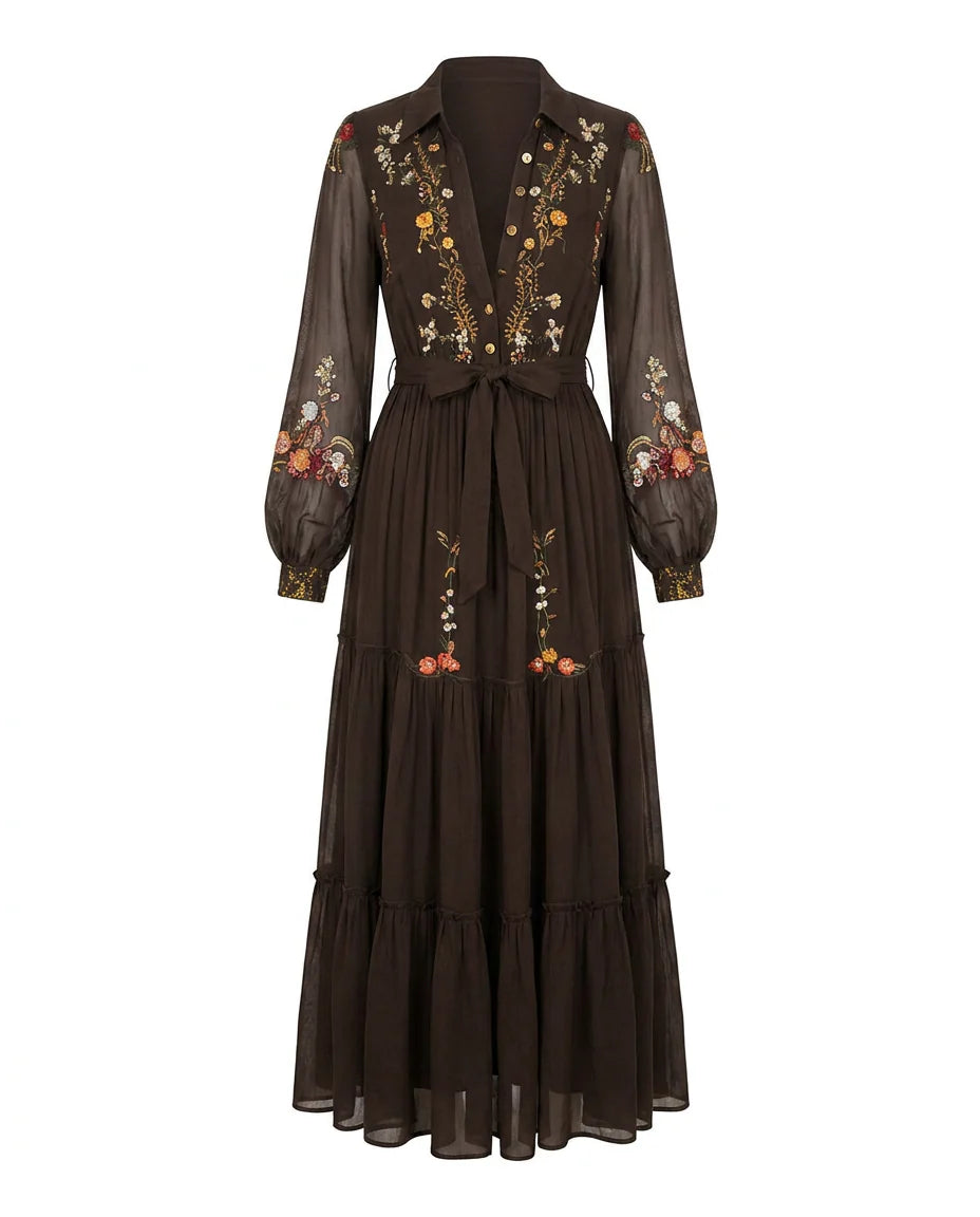 Embroidered maxi dress styled with tie waist belt showing defined silhouette and flowing skirt