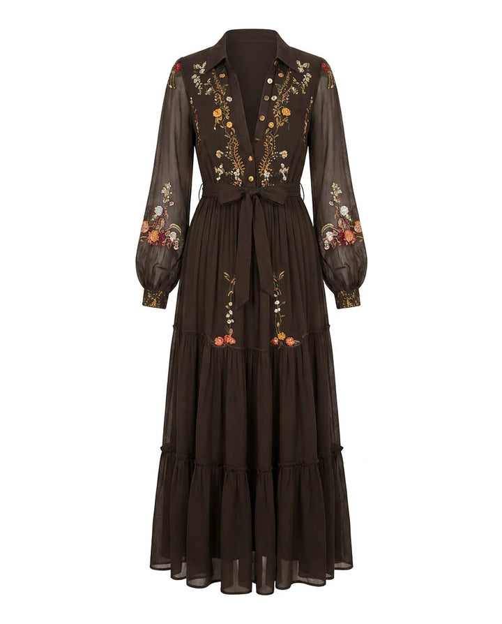 Embroidered maxi dress styled with tie waist belt showing defined silhouette and flowing skirt