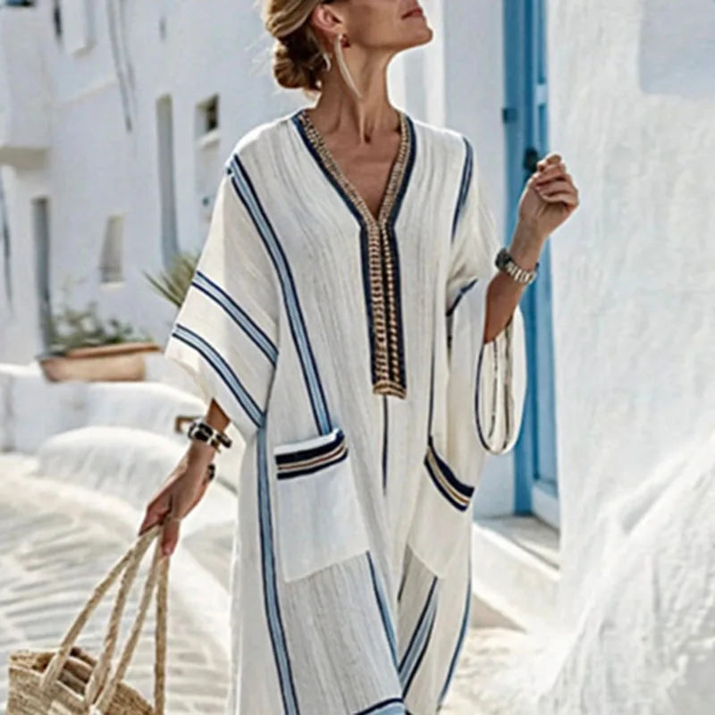 Side view of striped kaftan dress showing flowy sleeves and full-length relaxed silhouette