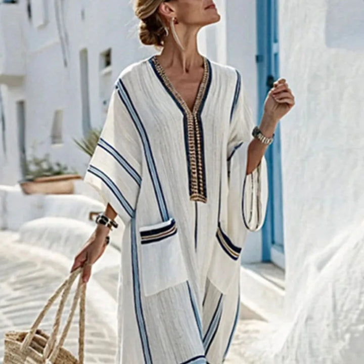 Side view of striped kaftan dress showing flowy sleeves and full-length relaxed silhouette