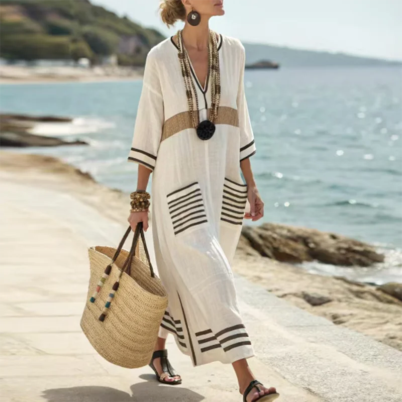 Back view of white striped kaftan dress with horizontal striped hem detailing
