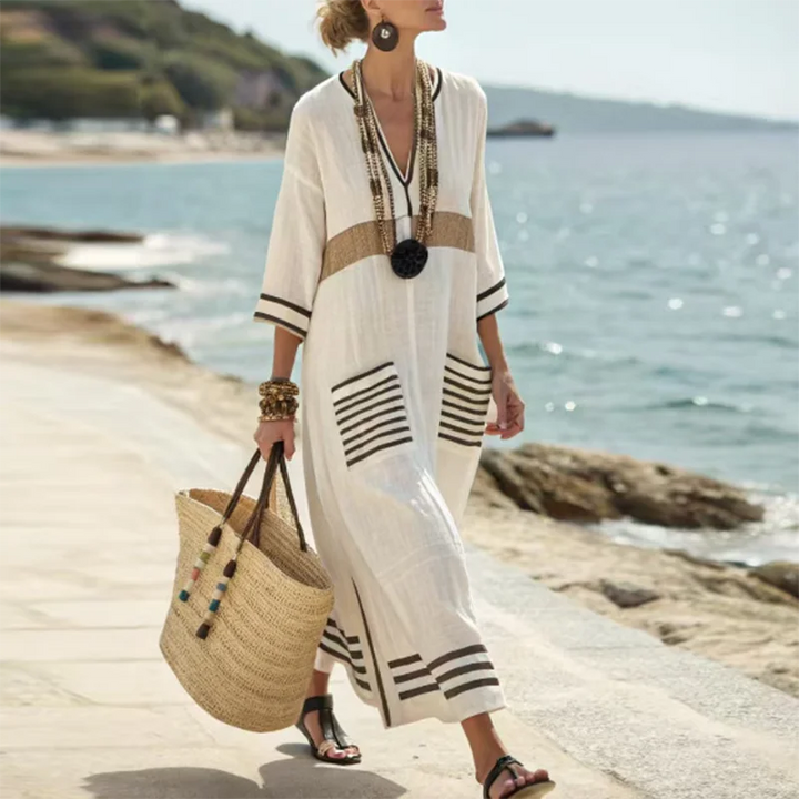 Back view of white striped kaftan dress with horizontal striped hem detailing