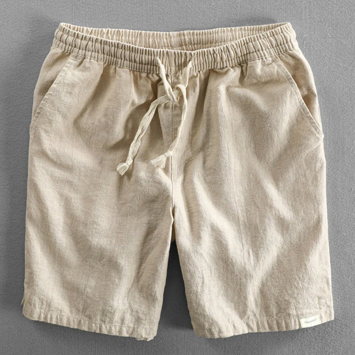 Detail of elastic waistband and drawstring tie on men's casual chino shorts in navy