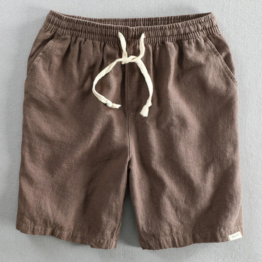 Men's chino shorts laid flat showing relaxed silhouette and textured woven fabric construction