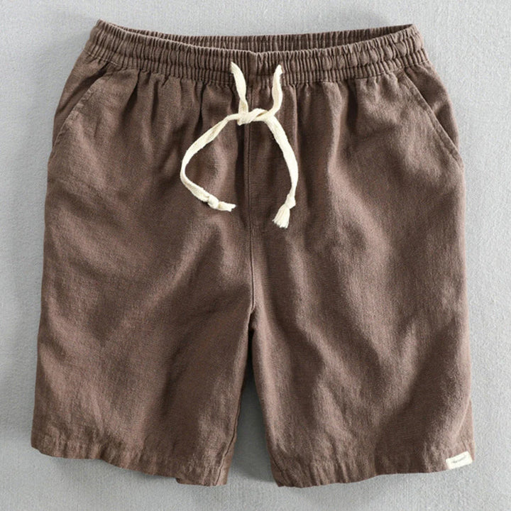 Men's chino shorts laid flat showing relaxed silhouette and textured woven fabric construction