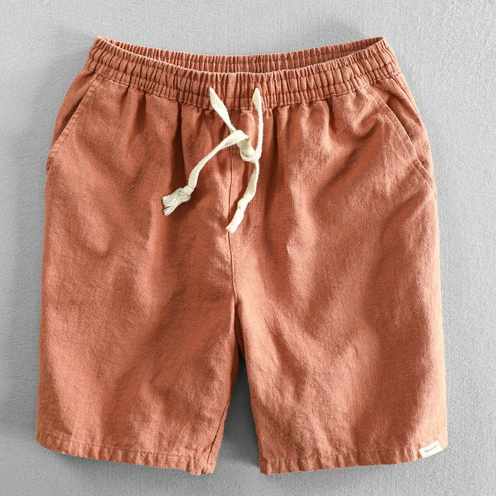 Men's mid-thigh chino shorts in navy blue with side pockets and adjustable waist