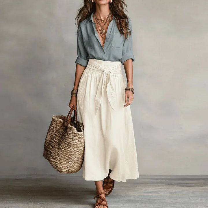 Woman wearing Linen Co-Ord Set with sage button-down shirt and cream tie-waist midi skirt