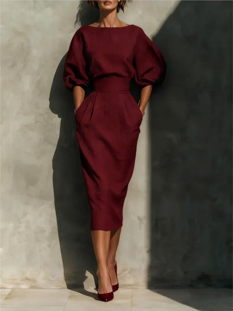 Side view of midi dress showing lantern sleeve detail and fitted bodice structure