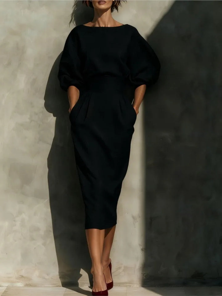 Midi dress silhouette showing pleated skirt movement and defined waist seam