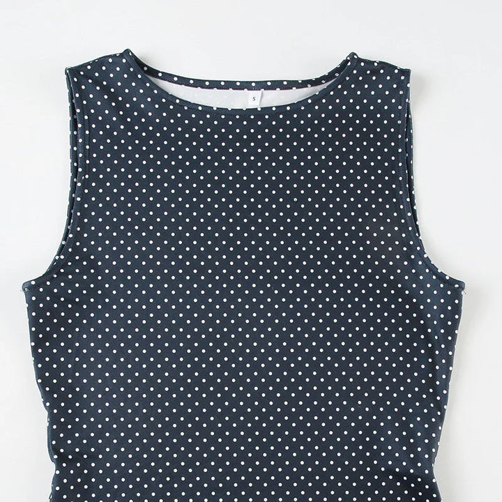 Full-length view of sleeveless polka dot mini dress blue paired with casual accessories