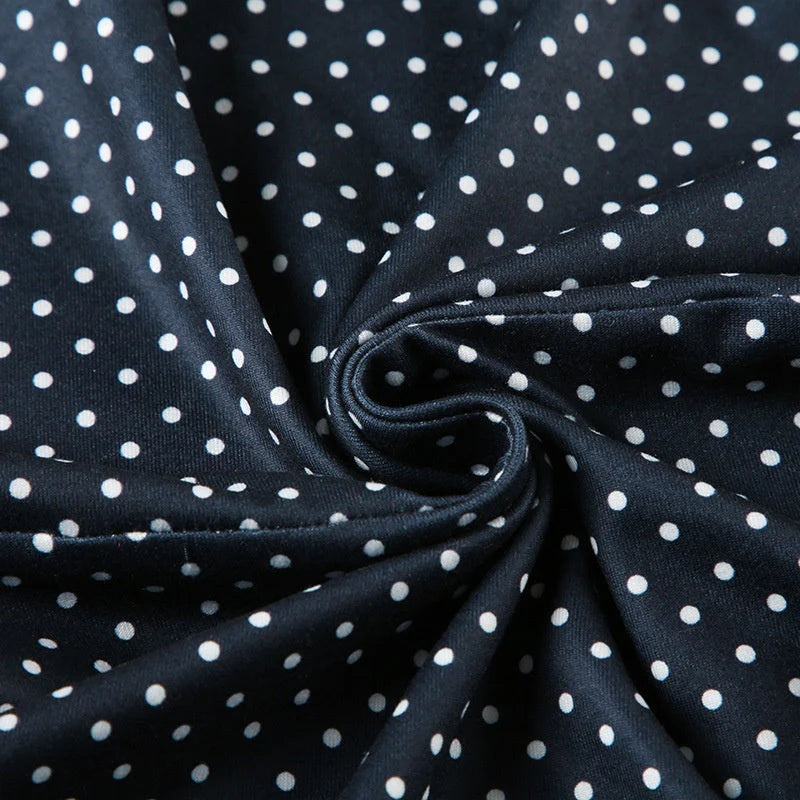 Woman styling sleeveless polka dot mini dress blue for casual daytime wear