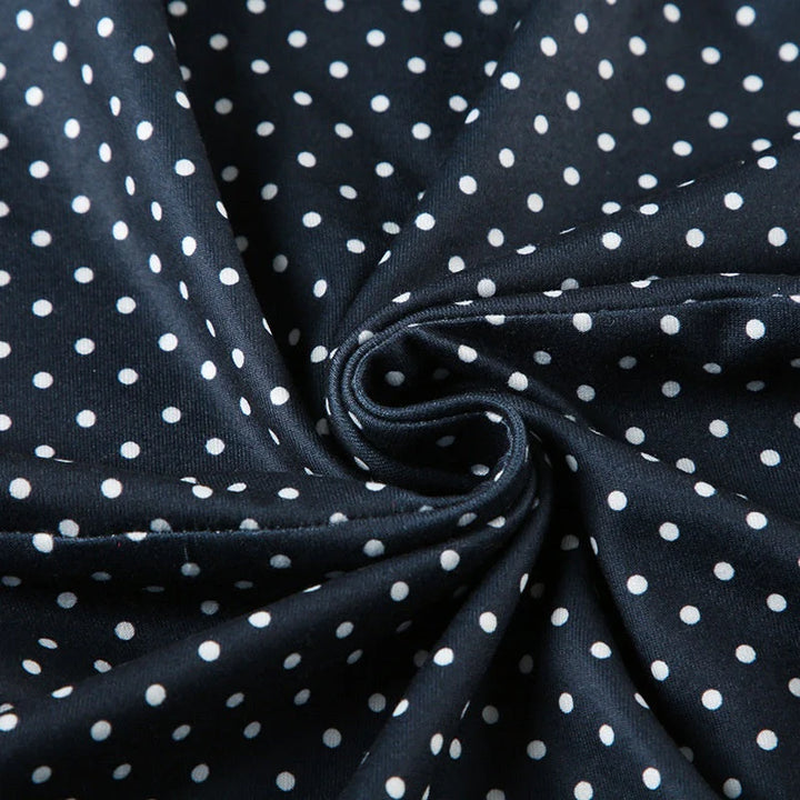 Woman styling sleeveless polka dot mini dress blue for casual daytime wear