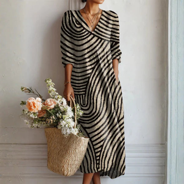 Summer midi dress with abstract geometric stripe pattern, V-neckline, three-quarter sleeves, and relaxed A-line fit for casual warm-weather wear