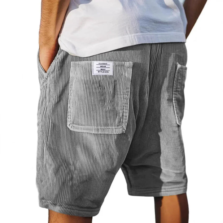 Men's relaxed fit cargo shorts in gray vertical stripe texture with flap pocket closures and elastic drawstring waistband