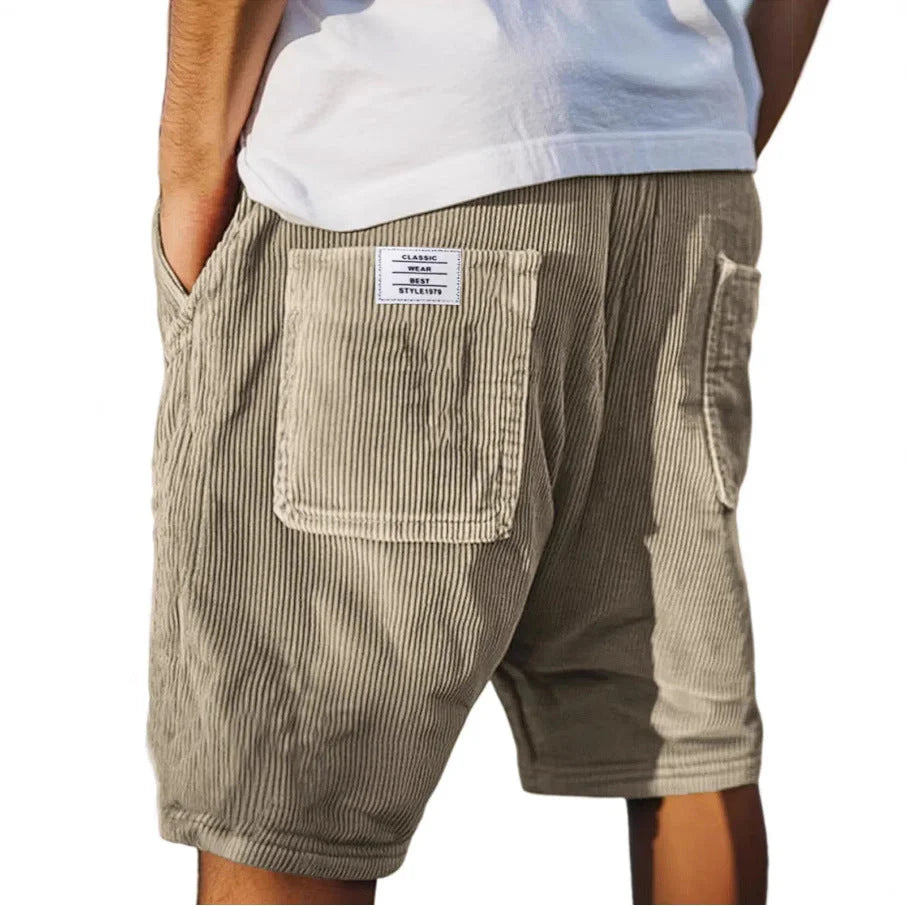 Back view of men's cargo shorts showing contrast label patch and utility pocket with flap closure detail