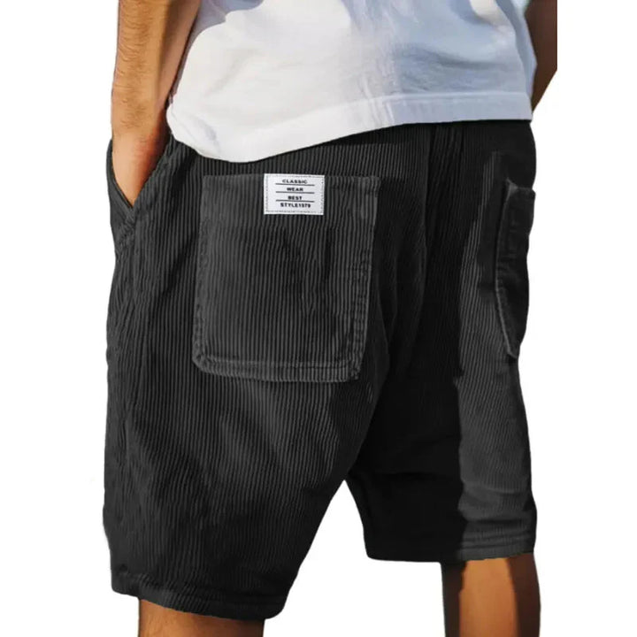 Men's stripe cargo shorts styled with white t-shirt showing relaxed silhouette and comfortable fit