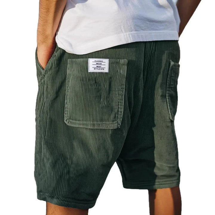 Detail view of cargo shorts pocket flap closure and structured vertical stripe weave fabric