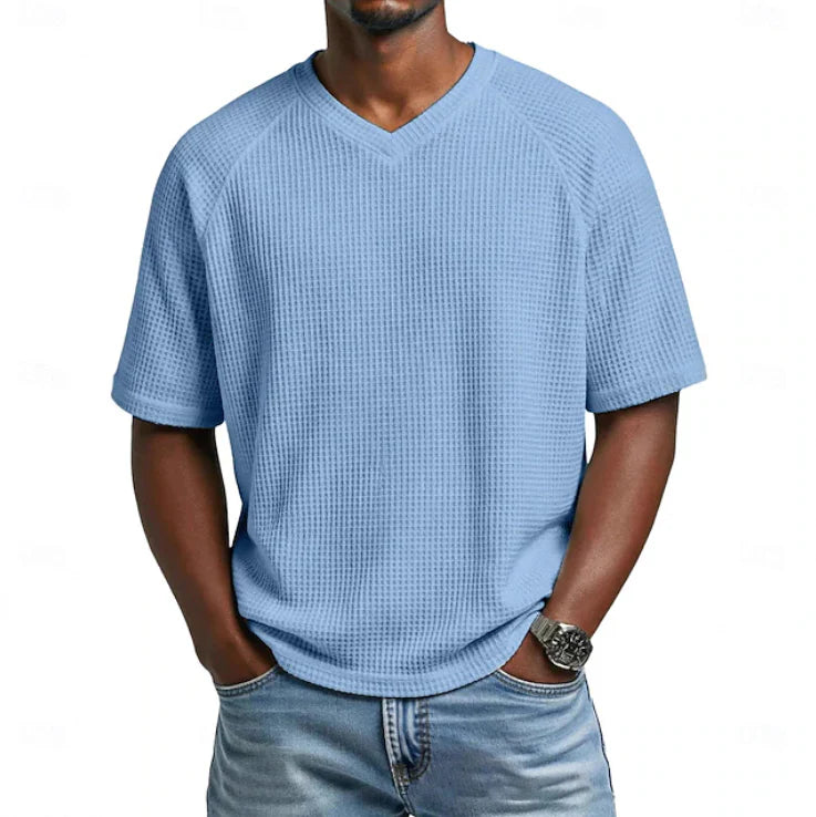 Man wearing light blue men's V-neck Short Sleeve Waffle tShirt with textured waffle weave and relaxed fit