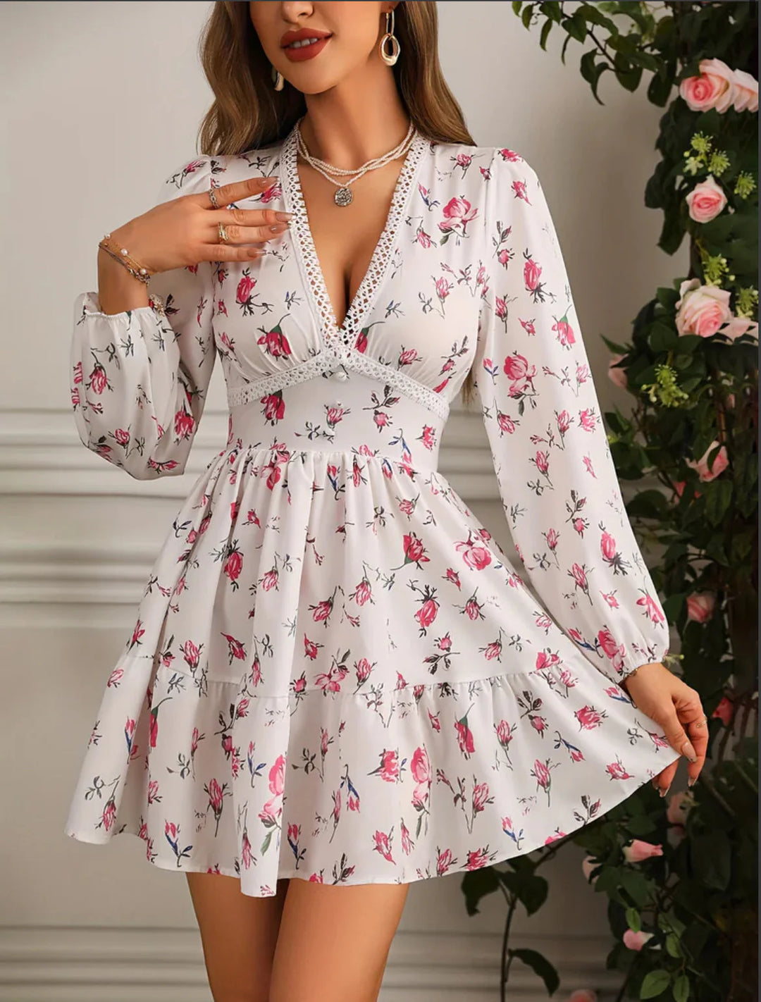 Close-up view of the V-neckline and puff sleeves on a floral mini dress with delicate lace trim detailing