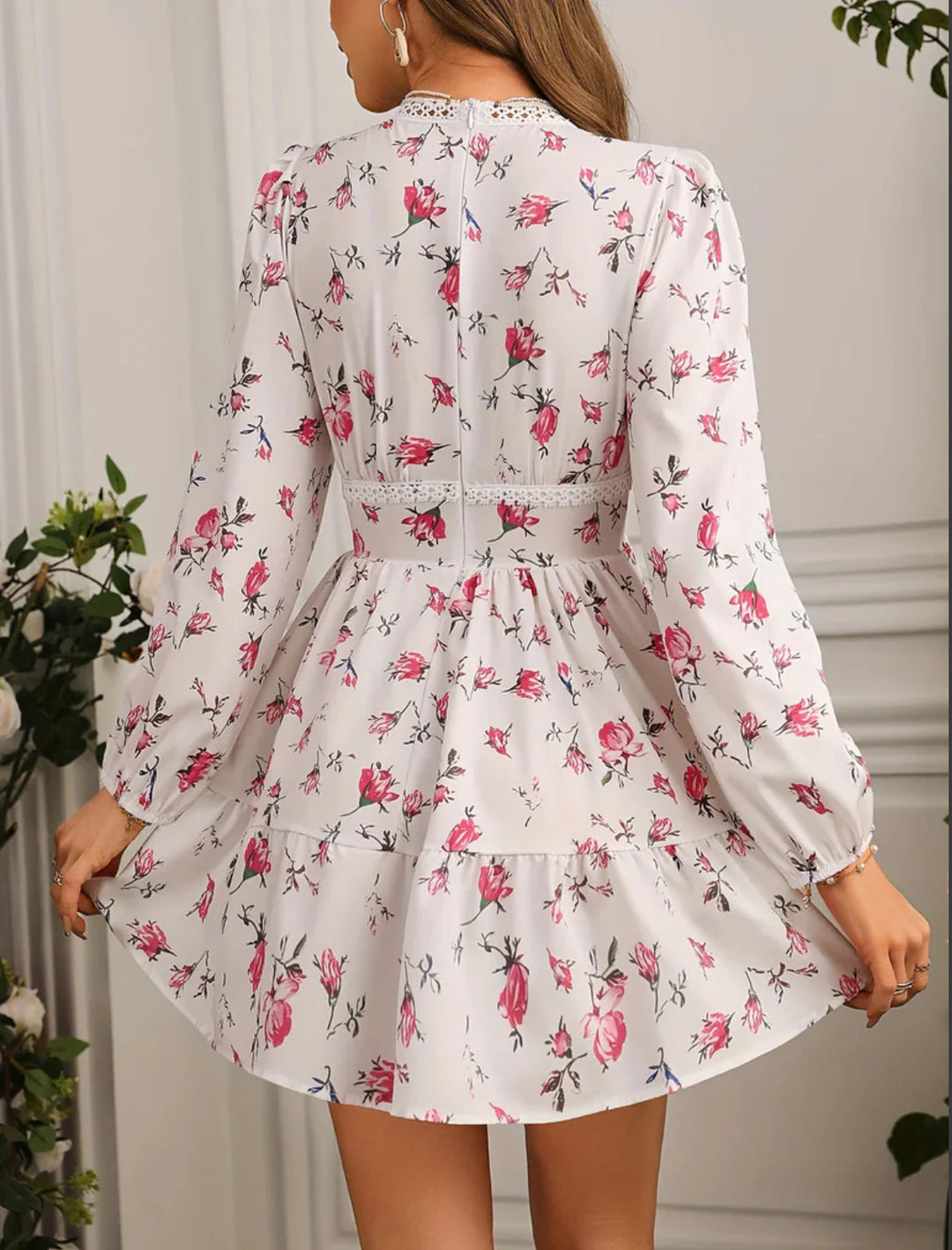 Detail shot of long puff sleeves with fitted cuffs on a floral mini dress in light tones