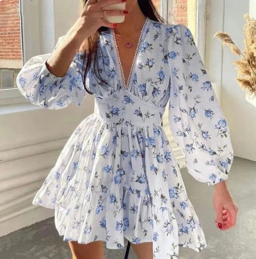 Full-length view of a floral mini dress with voluminous sleeves and playful tiered hemline for garden parties