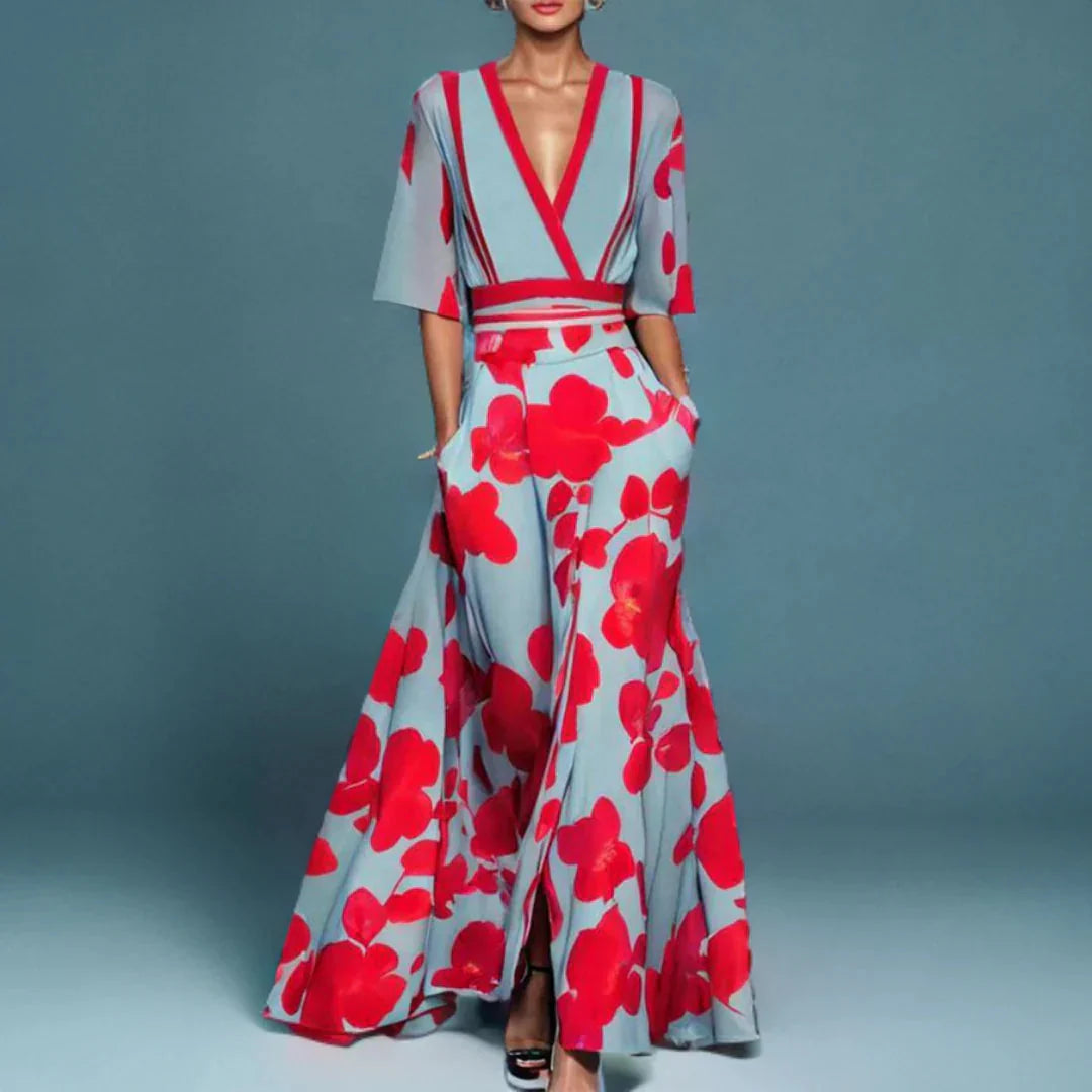 Floral wrap maxi dress with deep V-neckline, elbow sleeves, and bold floral print in contrasting tones on flowing skirt