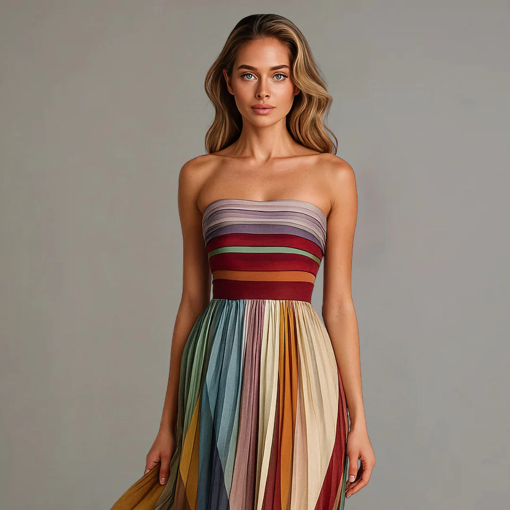 Front view of strapless maxi dress featuring fitted striped bodice and flowing pleated skirt