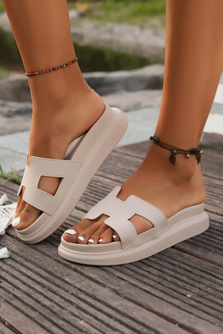 Overhead view of orthopedic platform slippers highlighting open-toe construction and cut-out detail