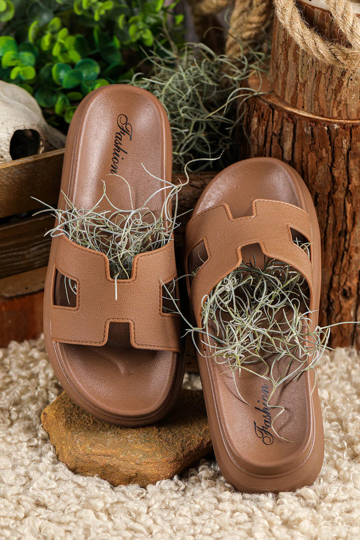 Women's platform slippers worn outdoors showing comfortable fit and modern cut-out design detail