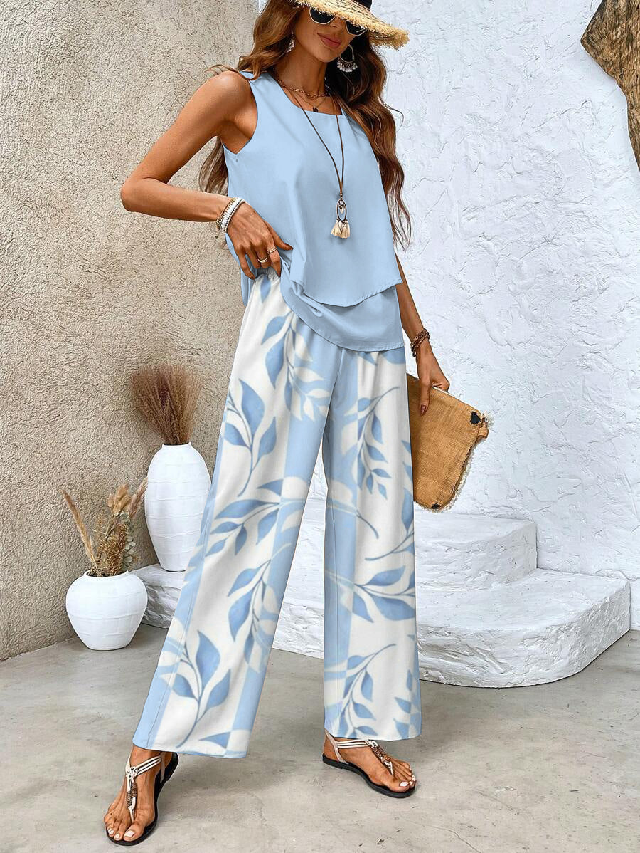 Back view of sleeveless layered top paired with wide-leg leaf print pants