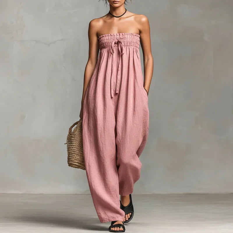 Front view of strapless off shoulder jumpsuit showing adjustable tie detail and flowing silhouette