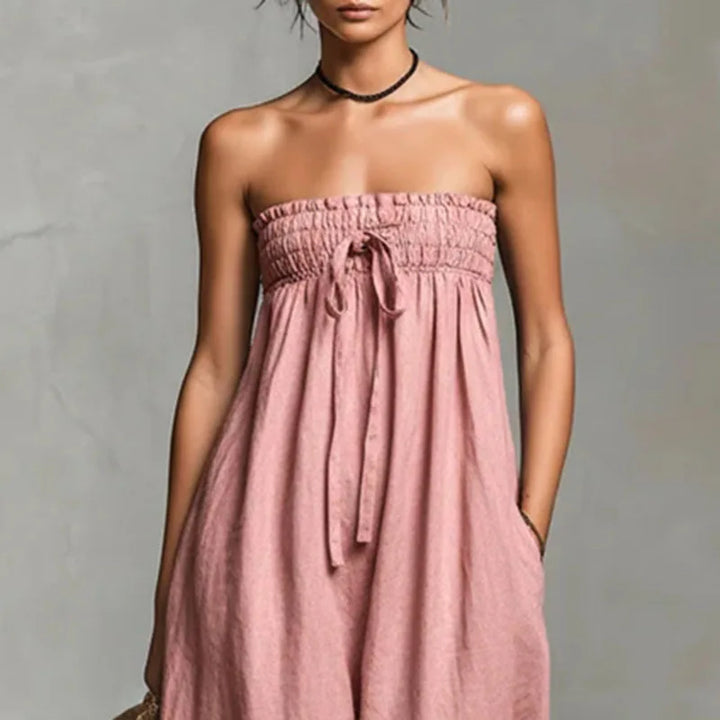 Side angle of wide leg off shoulder jumpsuit in lightweight fabric for warm weather