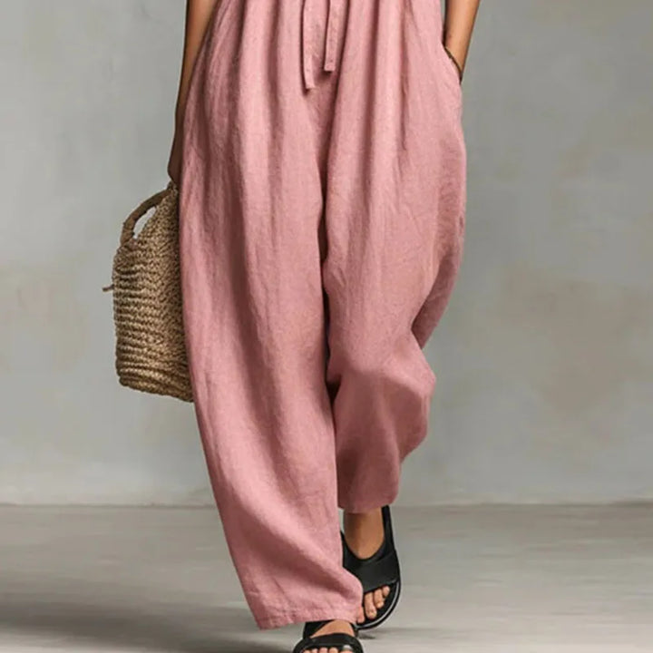 Detail shot of ruched strapless bodice on off shoulder jumpsuit with tie closure