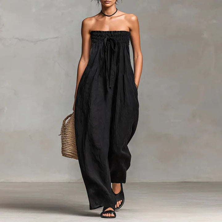 Full length view of relaxed fit off shoulder jumpsuit styled with sandals