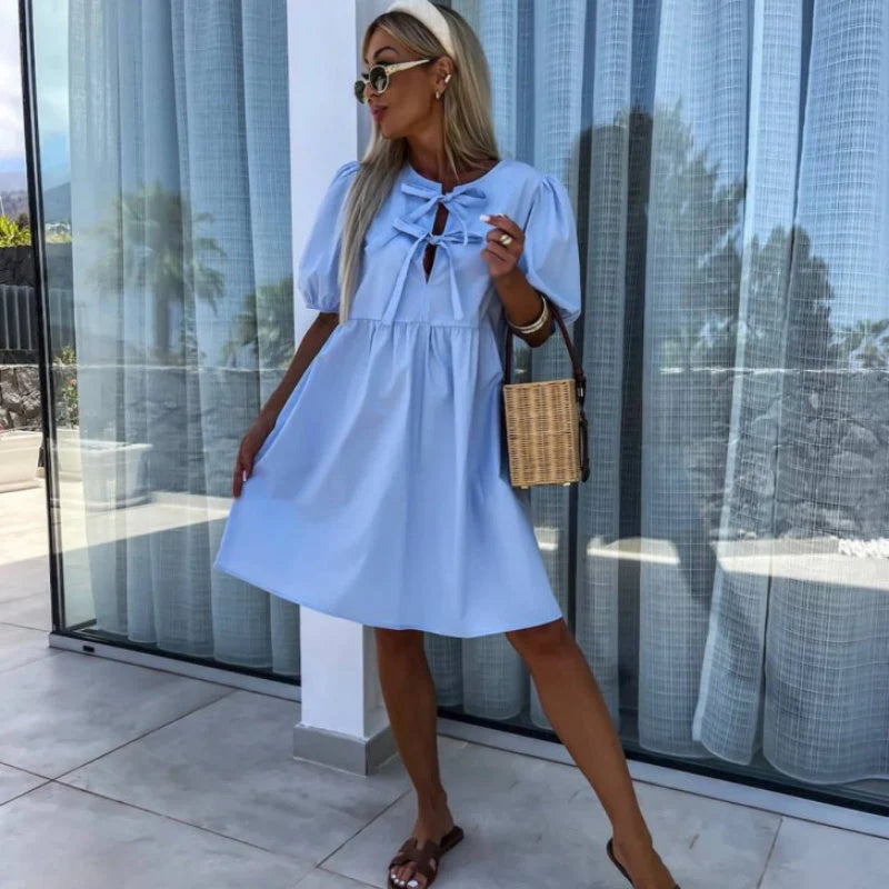 Mini Dress Puff Sleeves Bow Detail in light blue with relaxed above-the-knee silhouette and bow accents