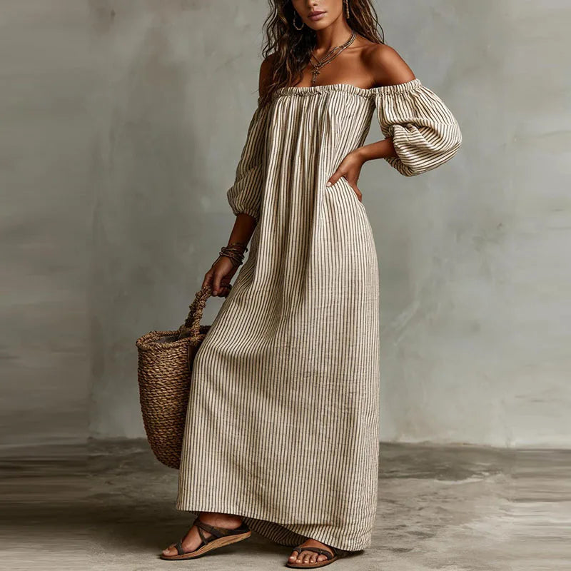 Detail of side pocket and vertical stripe pattern on off shoulder maxi dress