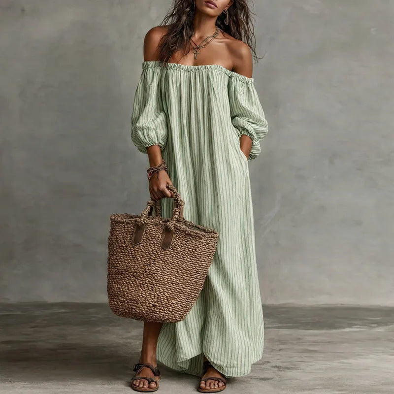 Off shoulder dress styled with accessories showing full maxi length and stripe detail