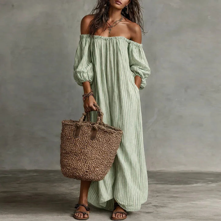 Off shoulder dress styled with accessories showing full maxi length and stripe detail