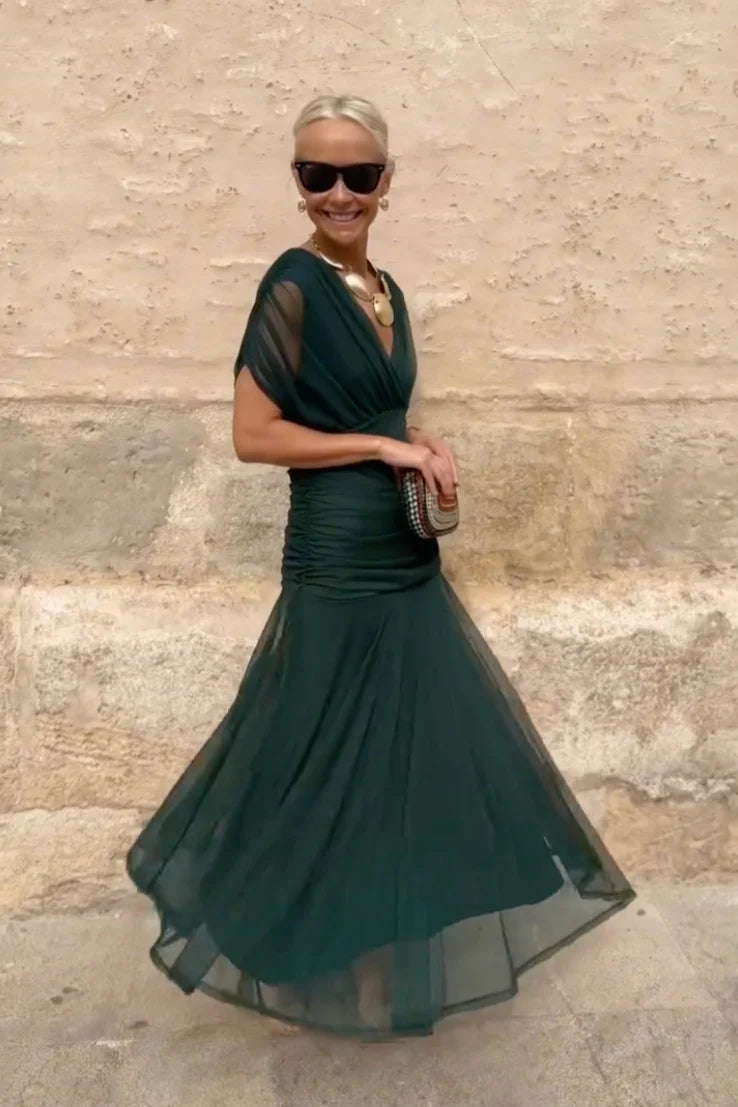 Maxi ceremony dress in green worn with heels for wedding guest or gala event