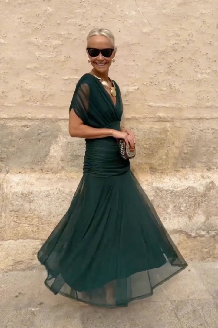Maxi ceremony dress in green worn with heels for wedding guest or gala event