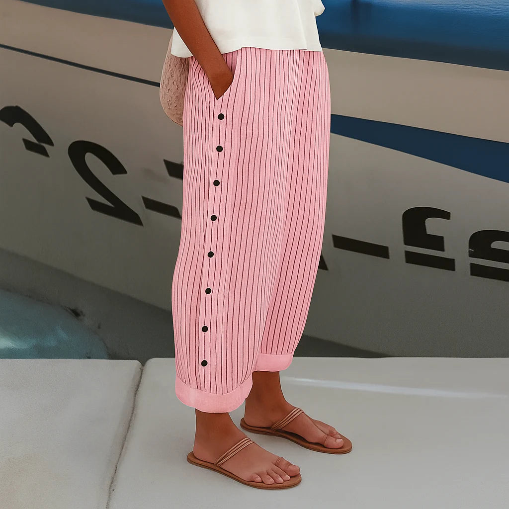 Full length view of women's mid-rise cropped pants with side pockets and button detail