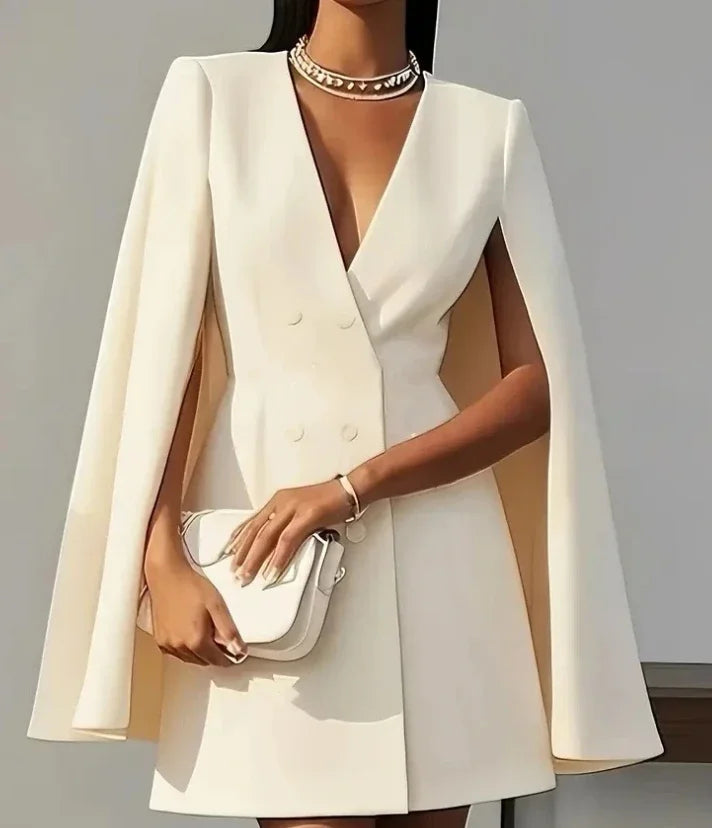 Woman wearing white V-Neck Blazer Dress with dramatic cape sleeves and double-breasted detailing in modern tailored silhouette