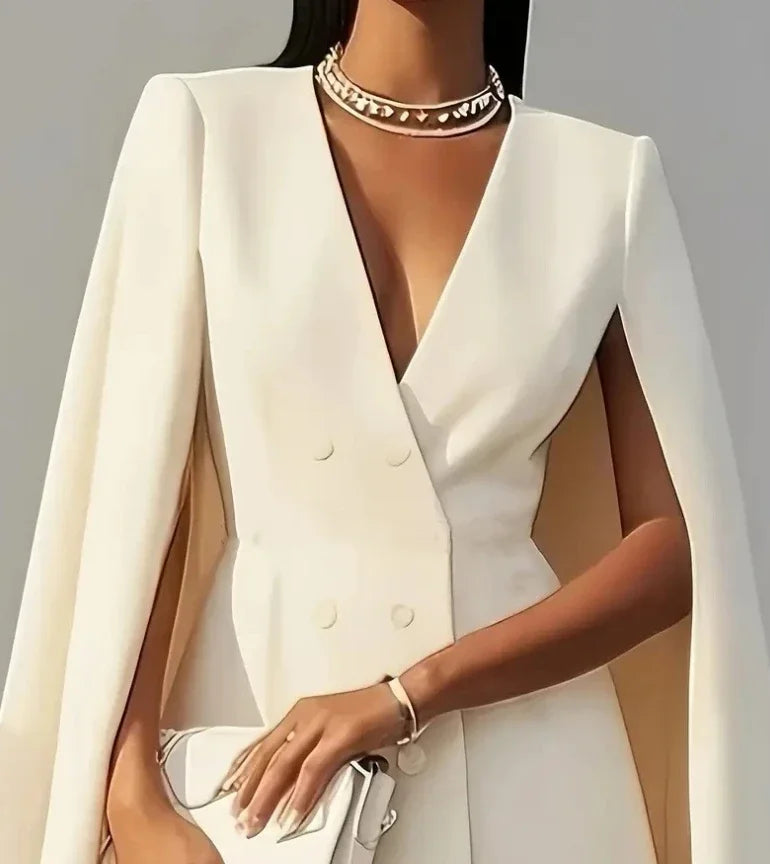 Side angle of cape sleeve blazer dress highlighting flowing sleeve drape and mini length hem