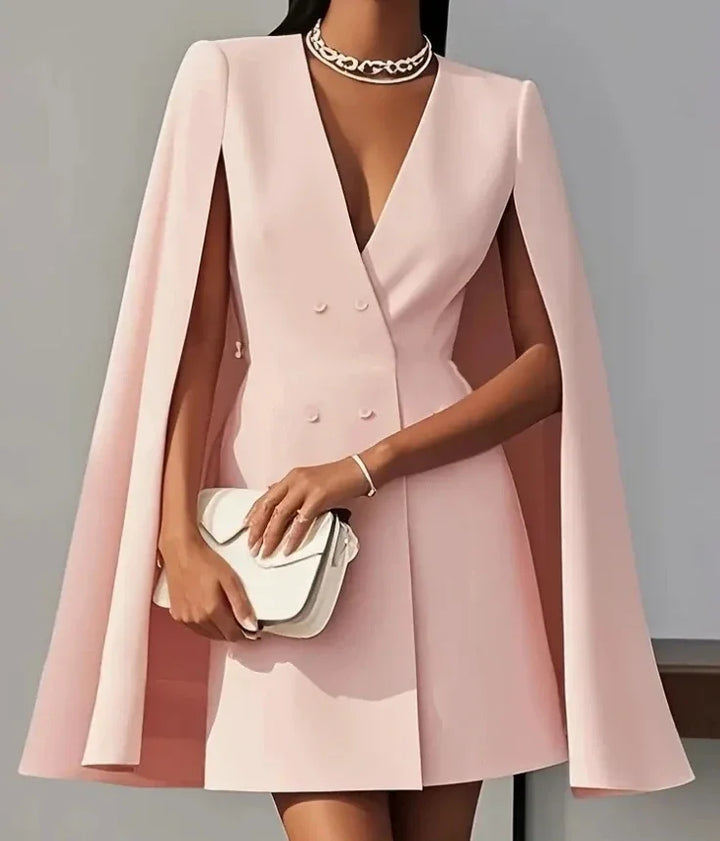 Back view of white blazer dress with cape sleeves showing tailored construction and clean lines