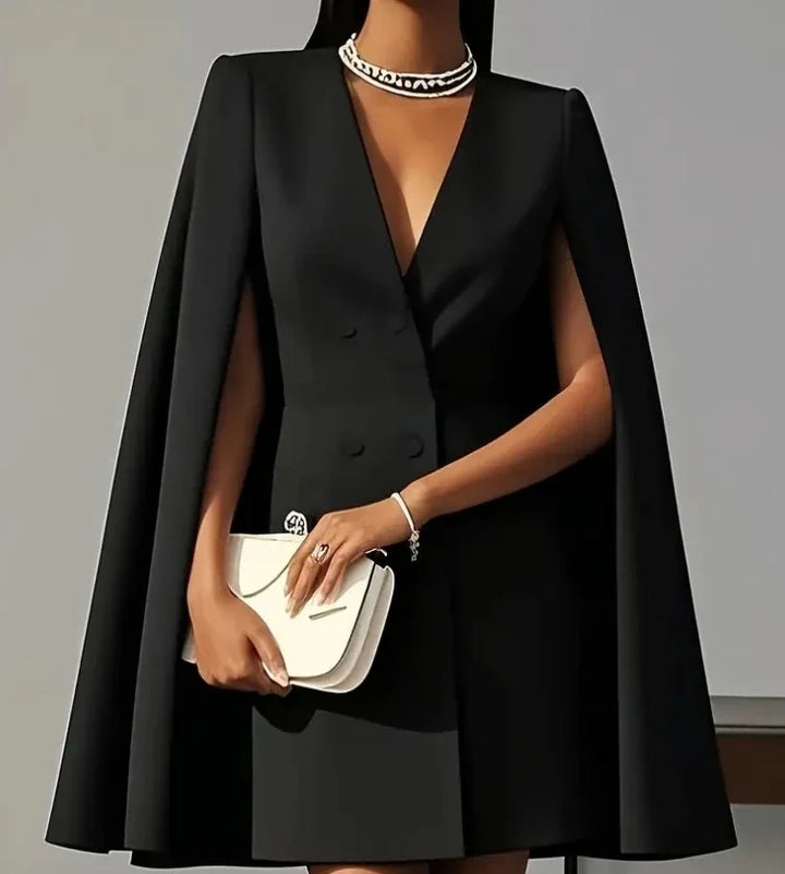 Full-length view of structured mini blazer dress with cape sleeves styled for formal occasions