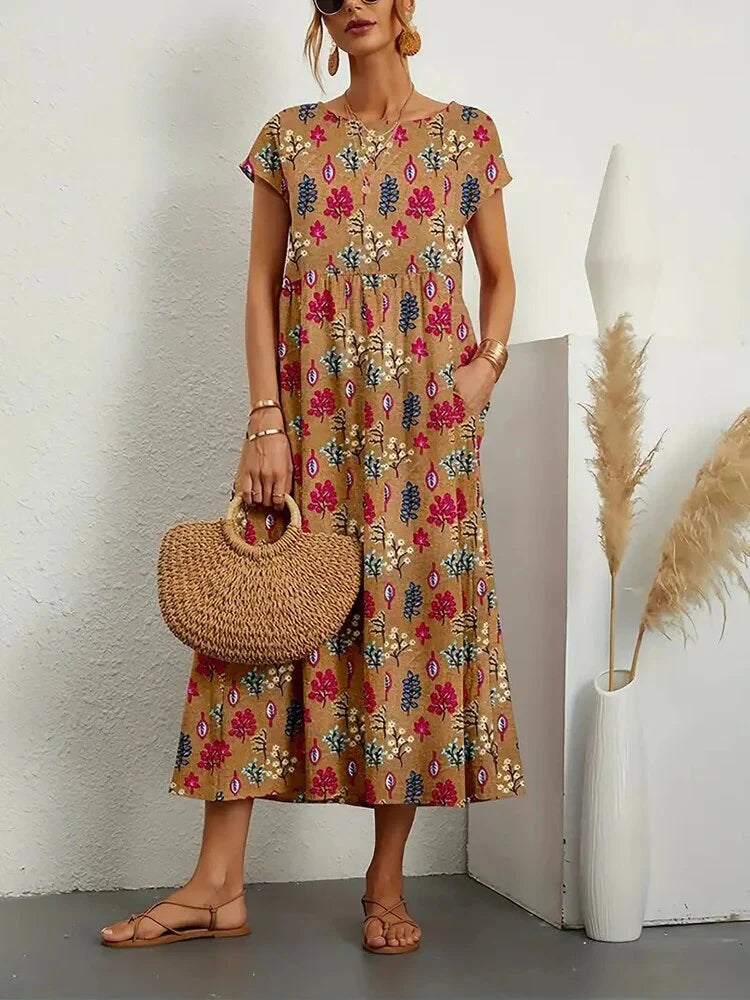 Close-up view of the floral print pattern featuring pink, navy, and cream blooms on camel fabric