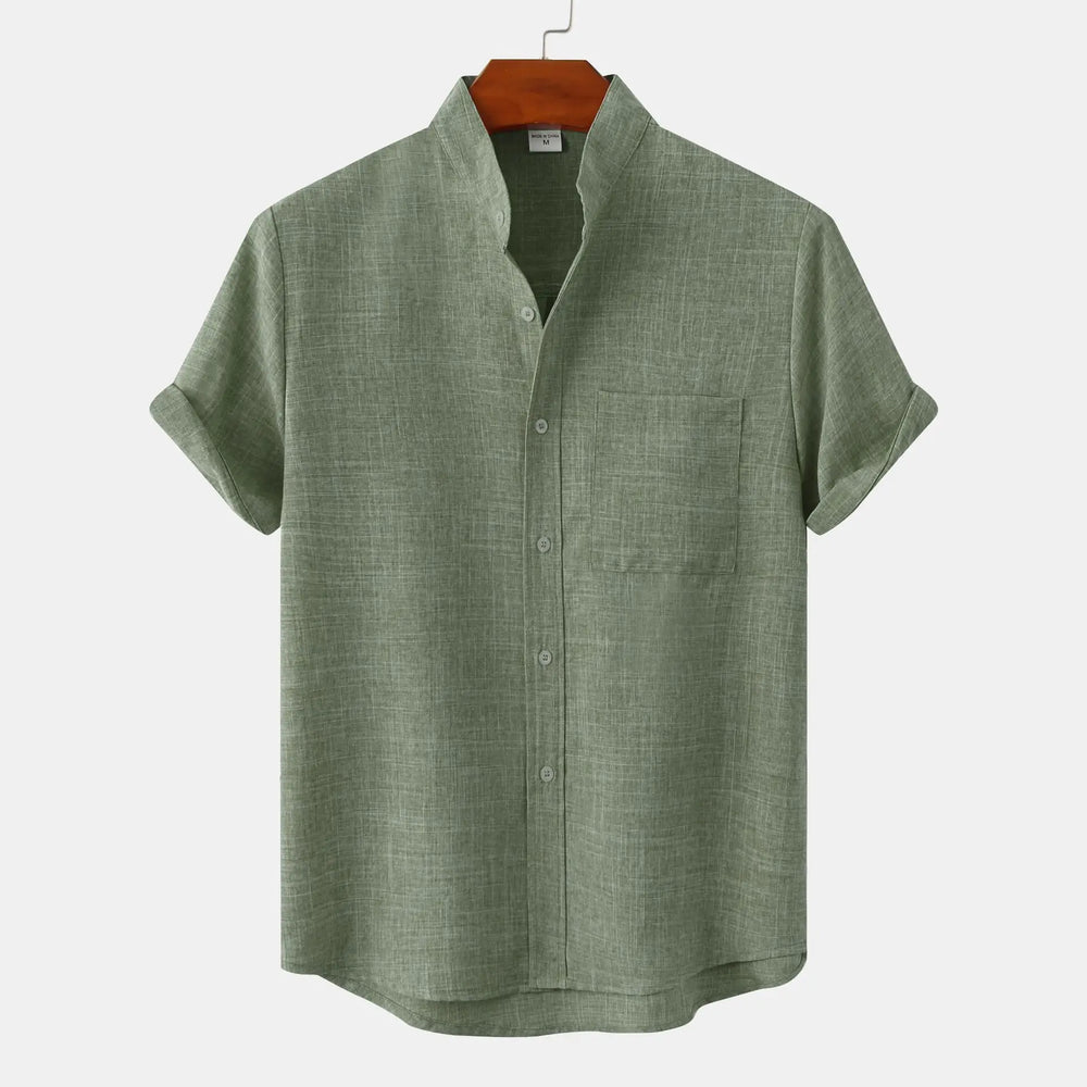 Close-up view of men's black button-up shirt showing rolled cuffs and button-front detail