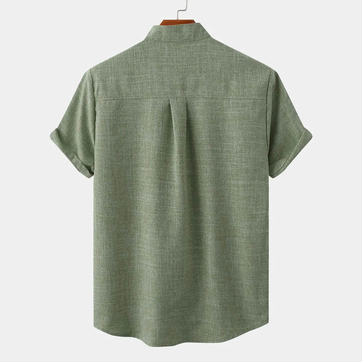 Side angle of men's relaxed fit short sleeve shirt displaying structured fabric drape