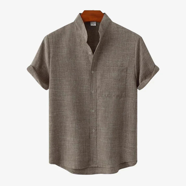 Flat lay of men's black casual button-up shirt with spread collar and pocket