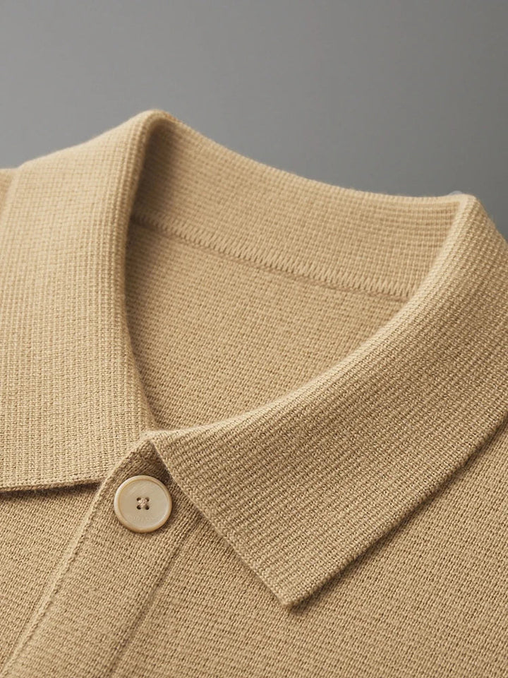 Front view of button-up polo sweater in cream showcasing full-button placket and collar styling